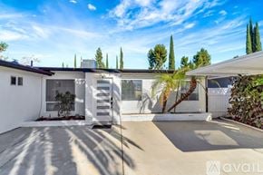 West Hills house for rent - A modern house with a white exterior and a large driveway.
