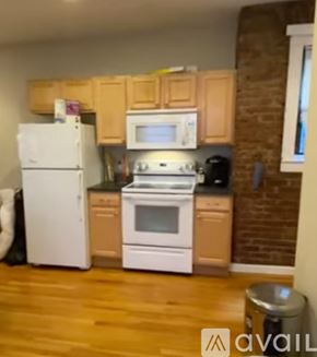 Boston apartment for rent - A kitchen with wooden cabinets and white appliances.
