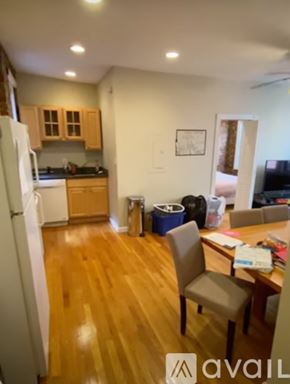 Boston apartment for rent - A kitchen with a refrigerator, table and chairs.