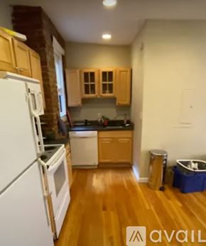 Boston apartment for rent - A kitchen with wooden floors and white appliances.