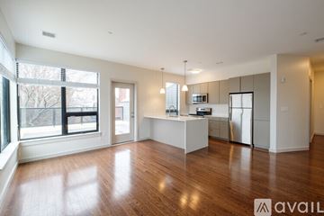 Brookline apartment for rent - A spacious kitchen with white cabinets and a wooden floor.