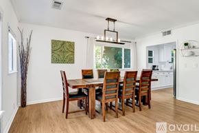 Los Angeles house for rent - A dining room with a wooden table and chairs.