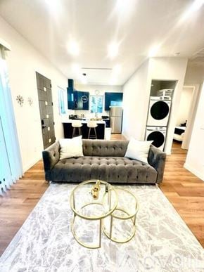 Los Angeles house for rent - A living room with a grey couch and a white rug.