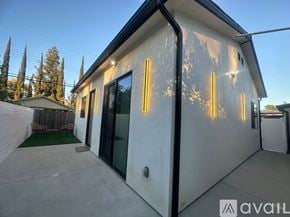 Los Angeles house for rent - A modern house with a white exterior and a black roof is available for rent.