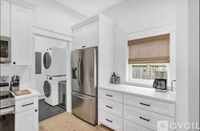 Santa Rosa Beach house for rent - A kitchen with white cabinets and stainless steel appliances.