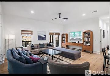 Santa Rosa Beach house for rent - A living room with a grey couch and a black coffee table.