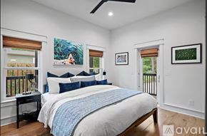 Santa Rosa Beach house for rent - A bedroom with a large bed and a painting of a woman on the wall.