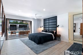 Los Angeles house for rent - A bedroom with a large bed and a balcony overlooking the pool.