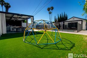 Los Angeles house for rent - A large blue and yellow playground structure sits in the middle of a green lawn.