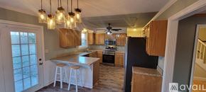 Clarksville house for rent - A hallway with wooden floors and white walls.
