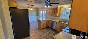 Clarksville house for rent - A room with wooden floors and a chandelier.