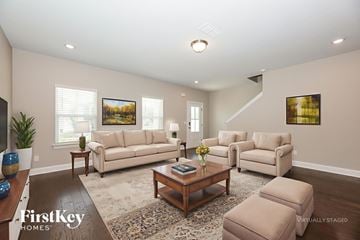 Hermitage house for rent - A living room with a brown coffee table and two beige couches.
