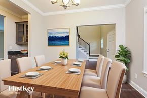 Clemmons house for rent - A dining room with a wooden table set for six.
