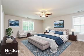 Clemmons house for rent - A bedroom with a large bed and a ceiling fan.