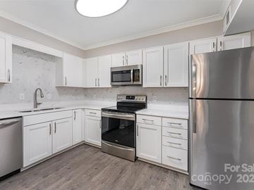 Charlotte apartment for rent - A kitchen with a stainless steel refrigerator, oven, and microwave.
