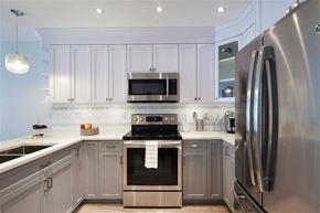 Vancouver apartment for rent - A modern kitchen with a stainless steel refrigerator and oven.