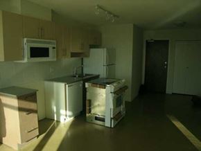Vancouver apartment for rent - A kitchen with white appliances and wooden cabinets.