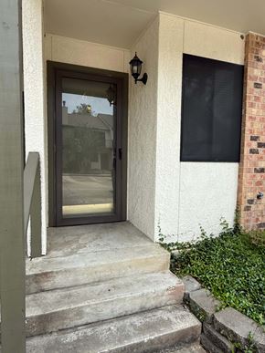 Lafayette apartment for rent - A glass door is on the left side of a white wall.