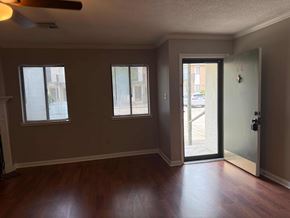 Lafayette apartment for rent - A room with a wooden floor and a sliding glass door.