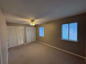 Lafayette apartment for rent - A room with a ceiling fan and two windows.