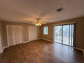 Lafayette apartment for rent - A room with a ceiling fan and sliding glass doors.
