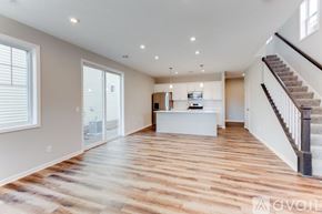 Ramsey house for rent - A spacious living room with a staircase on the right side.