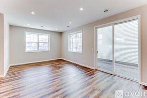 Ramsey house for rent - A spacious room with wooden floors and two windows.