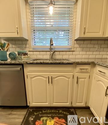 Blue Springs apartment for rent - A kitchen with white cabinets and a black counter top.