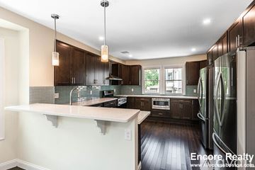 Medford house for rent - A modern kitchen with dark wood cabinets and stainless steel appliances.