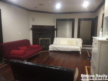 Brookline apartment for rent - A living room with a red couch and a white sofa.
