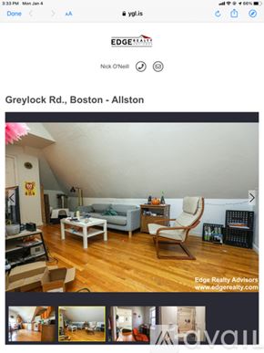 Boston apartment for rent - A living room with a grey couch, a white coffee table, and a wooden chair.
