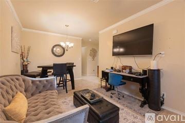 Wylie house for rent - A living room with a grey couch and a black television.