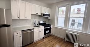 Boston apartment for rent - A kitchen with white cabinets and stainless steel appliances.