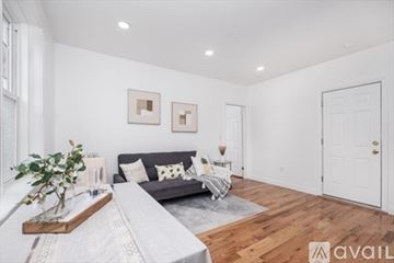 Boston apartment for rent - A living room with a grey couch and a wooden coffee table.