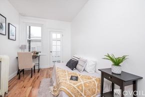 Boston apartment for rent - A bedroom with a bed, a desk, and a chair.