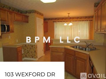 Lagrange house for rent - A kitchen with wooden cabinets and a sink is shown.