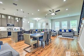 Dallas house for rent - A spacious kitchen and dining area with wooden floors and modern furniture.