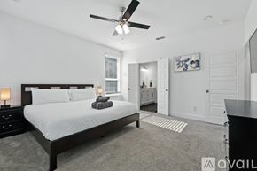 Dallas house for rent - A bedroom with a large bed and a ceiling fan.