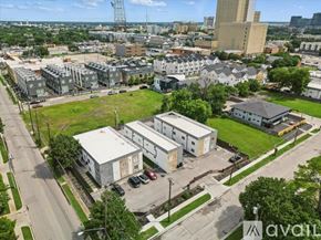 Dallas apartment for rent - A bird's eye view of a city with buildings, roads, and cars.