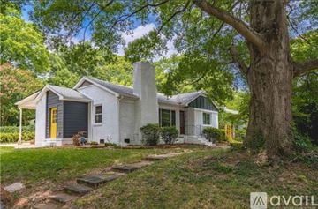 Charlotte house for rent - A house with a yellow door is for sale.
