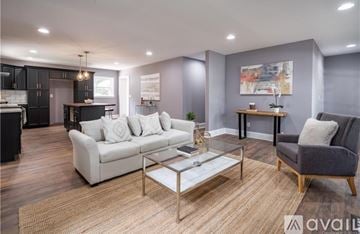 Charlotte house for rent - A modern living room with a white sofa and a glass coffee table.
