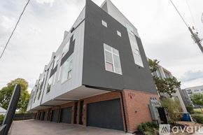 Dallas townhouse for rent - A modern two-story house with a garage on the ground floor.