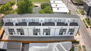 Dallas townhouse for rent - An aerial view of a white building with a grey roof.
