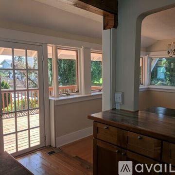 St. Helens house for rent - A kitchen with a wooden counter and a window with a view of a house.