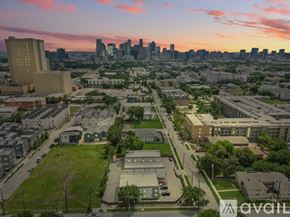 Dallas apartment for rent - A cityscape with buildings and a sunset in the background.