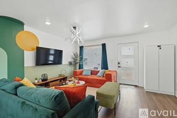 Dallas apartment for rent - A living room with a green couch and a red couch.