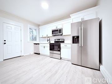 Stamford house for rent - A kitchen with white cabinets and appliances.