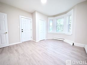 Stamford house for rent - A room with white doors and a window with a view of trees.