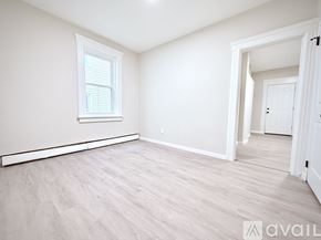 Stamford house for rent - A spacious room with light wood flooring and white walls.