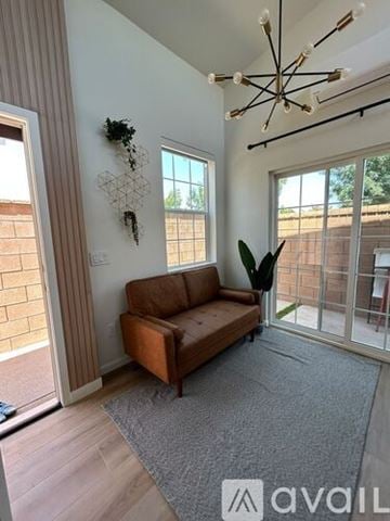 Ontario townhouse for rent - A living room with a brown couch and a hanging plant.